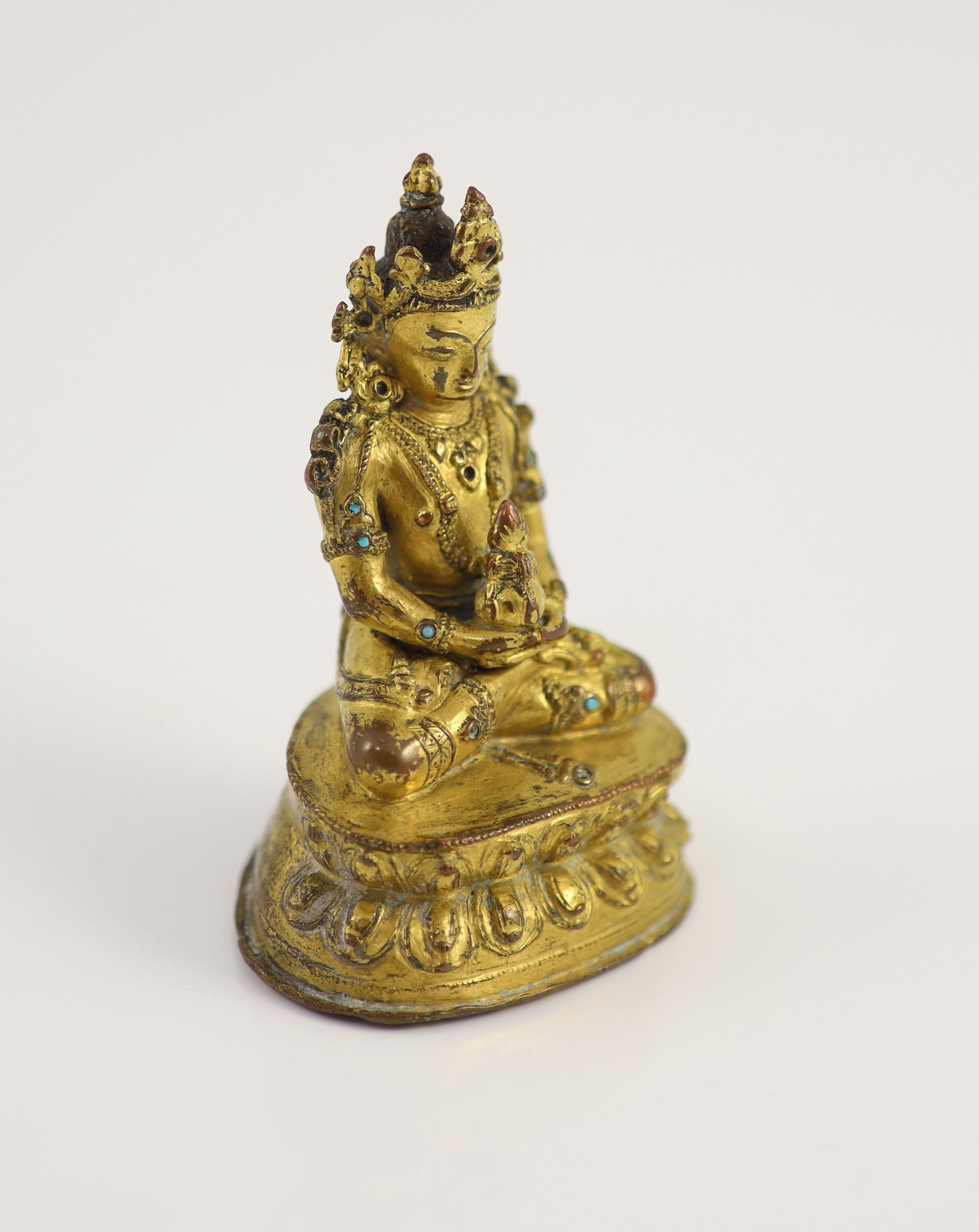 A Tibetan gilt copper alloy seated figure of Amitayus, possibly 15th/16th century, 9cm high